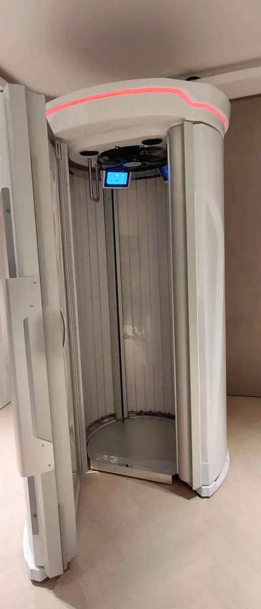 Assembled therapy chamber with both doors open, showing the internal lamp array and floor plate