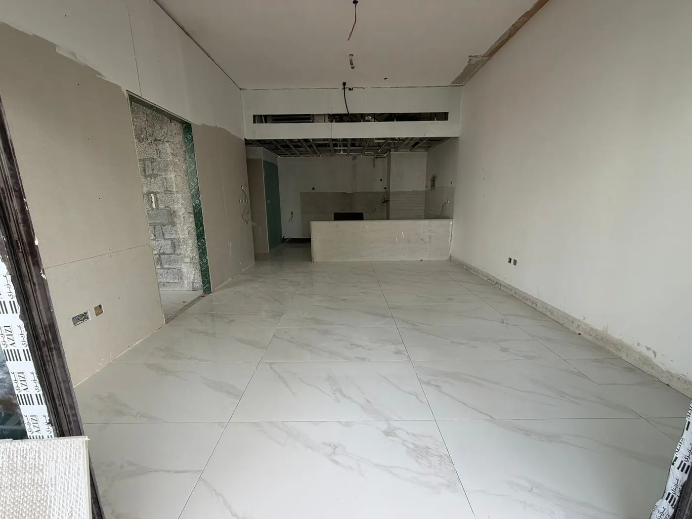 Tiled kitchen recess with services capped and left ready for appliance connection