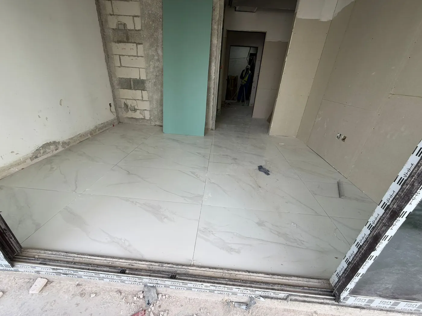 Room with large-format floor tiling complete and grouted